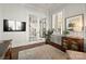 Cozy living room with french doors, hardwood floors, built-in shelving, and a large television at 1117 Churchill Commons Dr, Charlotte, NC 28211