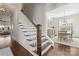 Elegant staircase with wooden steps and white railing at 1117 Churchill Commons Dr, Charlotte, NC 28211