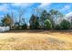 Private backyard with mature trees and a large grassy area at 11828 Bending Branch Rd # 42, Charlotte, NC 28227