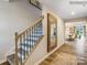 Elegant wooden staircase with wrought iron spindles and a large mirror in the hallway at 2509 Trollinger Dr, Catawba, NC 28609