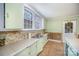 Kitchen with light green cabinets and a double sink at 302 Charlotte St, York, SC 29745