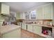 Kitchen features light green cabinets and tile flooring at 302 Charlotte St, York, SC 29745