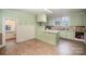 Kitchen with light green cabinets and tile floor at 302 Charlotte St, York, SC 29745