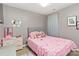 Bright bedroom with a soft pink theme, featuring ample space and cozy decor, perfect for relaxation at 4609 Emily Pl, Rock Hill, SC 29732