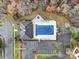 Aerial view of community pool, parking lot, and surrounding landscape at 8411 Washoe Pine Ln, Charlotte, NC 28215