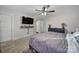 Main bedroom with gray bedding and mounted TV at 8411 Washoe Pine Ln, Charlotte, NC 28215