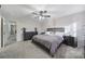 Main bedroom with gray bedding and ceiling fan at 8411 Washoe Pine Ln, Charlotte, NC 28215