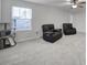 Spacious bonus room with two recliners and a cat tree at 8411 Washoe Pine Ln, Charlotte, NC 28215