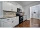 Kitchen with white cabinets, granite counters and black appliances at 8411 Washoe Pine Ln, Charlotte, NC 28215