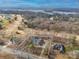 Aerial view of a house on a large lot near a golf course and lake, with mature trees surrounding the property at 1115 Stony Point Rd, Kings Mountain, NC 28086