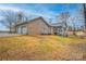 Brick home with a three-car garage and large grassy backyard, perfect for outdoor activities at 1115 Stony Point Rd, Kings Mountain, NC 28086