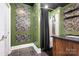 Stylish bathroom features a marble shower, wood vanity, and bold floral wallpaper for a unique design at 1115 Stony Point Rd, Kings Mountain, NC 28086