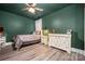 Relaxing bedroom with wood floors, ceiling fan, neutral bedding, and ample natural light at 1115 Stony Point Rd, Kings Mountain, NC 28086
