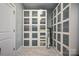 Well-organized closet featuring floor to ceiling shelving with frosted glass doors and marble flooring at 1115 Stony Point Rd, Kings Mountain, NC 28086