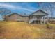 Back of brick house featuring a screened in porch, walk out basement, and green backyard at 1115 Stony Point Rd, Kings Mountain, NC 28086