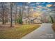 Beautiful brick home with a circular driveway, mature trees, and well-maintained landscaping in a serene setting at 1115 Stony Point Rd, Kings Mountain, NC 28086
