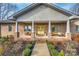 Inviting front porch with yellow doors, ample seating, and meticulous landscaping for a welcoming curb appeal at 1115 Stony Point Rd, Kings Mountain, NC 28086
