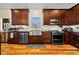Contemporary kitchen with stainless steel appliances, wood cabinets and hardwood floors at 1115 Stony Point Rd, Kings Mountain, NC 28086