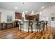 Open concept Kitchen with island, dark cabinets, hardwood floors, and breakfast bar at 1115 Stony Point Rd, Kings Mountain, NC 28086