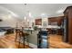 Modern kitchen with stainless steel appliances, dark wood cabinetry, and a breakfast bar overlooking the dining area at 1115 Stony Point Rd, Kings Mountain, NC 28086