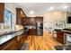 Modern kitchen features stainless steel appliances, dark wood cabinets and hardwood floors at 1115 Stony Point Rd, Kings Mountain, NC 28086
