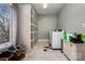 Functional laundry room with white cabinets, shelving, marble floors, and natural light at 1115 Stony Point Rd, Kings Mountain, NC 28086