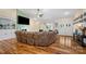 Open living room with hardwood floors, vaulted ceiling, modern fireplace, and a large sectional sofa for comfort at 1115 Stony Point Rd, Kings Mountain, NC 28086