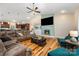 Spacious living room with hardwood floors, vaulted ceilings, modern fireplace, and an open-concept design to the kitchen at 1115 Stony Point Rd, Kings Mountain, NC 28086
