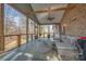 Comfortable screened-in sunroom with vaulted ceilings, exposed beams, and ample seating at 1115 Stony Point Rd, Kings Mountain, NC 28086