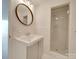Clean bathroom features glass enclosed shower, modern vanity, and round mirror at 1300 Queens Rd # 303, Charlotte, NC 28207