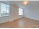A bright bedroom with neutral walls, lots of light, and laminate floors at 1300 Queens Rd # 303, Charlotte, NC 28207