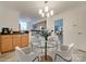 Bright dining area with a glass table, white chairs, and view of the modern kitchen at 1300 Queens Rd # 303, Charlotte, NC 28207