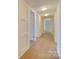 Hallway with laminate floors and white trim at 1300 Queens Rd # 303, Charlotte, NC 28207