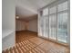 Sunlit living room with hardwood floors and large windows with shutters at 1300 Queens Rd # 303, Charlotte, NC 28207