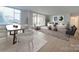 Open-concept living space with modern furnishings, dining area, and ample natural light at 1300 Queens Rd # 303, Charlotte, NC 28207