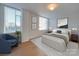 Bright main bedroom with a queen size bed, neutral walls, and two large windows at 1300 Queens Rd # 303, Charlotte, NC 28207