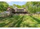 Exterior of the home showing the stone foundation, deck and large backyard at 15215 Timberview Ln, Huntersville, NC 28078