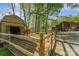 A barn and fenced area with a picnic table present on the property at 15215 Timberview Ln, Huntersville, NC 28078