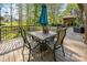 Outdoor dining on the deck features a table with four chairs and a shady umbrella at 15215 Timberview Ln, Huntersville, NC 28078