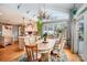 Well-lit dining area showcasing hardwood floors, a wooden table, and seamlessly connected to the adjacent kitchen at 15215 Timberview Ln, Huntersville, NC 28078