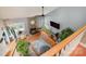Second floor view of inviting living room with stone fireplace, vaulted ceiling, wood floors, and cozy seating at 15215 Timberview Ln, Huntersville, NC 28078