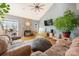 Inviting living room with stone fireplace, vaulted ceiling, wood floors, and cozy seating, creating a warm and stylish ambiance at 15215 Timberview Ln, Huntersville, NC 28078