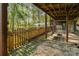 Back patio features a fenced yard, swings, stone accents, and lush surroundings at 15215 Timberview Ln, Huntersville, NC 28078