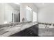 Bathroom featuring double sink vanity with granite countertop and a soaking tub at 174 Bellingshire Dr, Mt Ulla, NC 28125