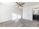 Neutral bedroom featuring plush carpet, a ceiling fan, and an ensuite bathroom at 174 Bellingshire Dr, Mt Ulla, NC 28125