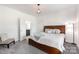 Cozy bedroom with a wood bed frame, carpet floors, a decorative ceiling lamp, and ensuite bathroom at 174 Bellingshire Dr, Mt Ulla, NC 28125