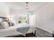 Bright bedroom features carpet flooring, ensuite access, a ceiling lamp, and large windows at 174 Bellingshire Dr, Mt Ulla, NC 28125