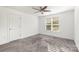 Neutral bedroom featuring plush carpet, a ceiling fan, and natural light from a window at 174 Bellingshire Dr, Mt Ulla, NC 28125