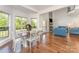 Bright dining area with large windows, hardwood floors, and a view of the living room at 174 Bellingshire Dr, Mt Ulla, NC 28125