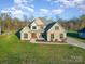Stunning two-story home with stone accents, well-manicured lawn and mature trees at 174 Bellingshire Dr, Mt Ulla, NC 28125